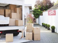 Boxes on ground near moving van