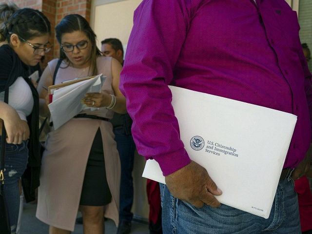 Newly sworn in US citizens wait in line to apply for Social Security cards following a naturalization ceremony at El Paso County Coliseum on April 18, 2019 in El Paso, Texas. - About 740 immigrants from countries throughout the world were sworn in as US citizens. (Photo by Paul Ratje …