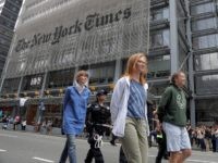 Activists are taken into custody by New York Police officers during a climate change rally outside of the New York Times building, Saturday, June 22, 2019, in New York. Activists blocked traffic along 8th Avenue during a sit-in to demand coverage of climate change by the newspaper. (AP Photo/Julio Cortez)