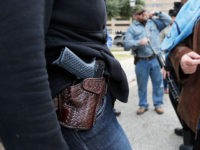 AUSTIN, TX - JANUARY 1: Two women compare handgun holsters during an open carry rally at the Texas State Capitol in Austin, Texas. On January 1, 2016, the open carry law took effect in Texas, and 2nd Amendment activists held an open carry rally at the Texas state capitol on …