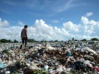 A boy walks at a garbage dump in Dala, on the outskirt of Yangon, on June 4, 2018. (Photo by Ye Aung THU / AFP) (Photo credit should read YE AUNG THU/AFP/Getty Images)