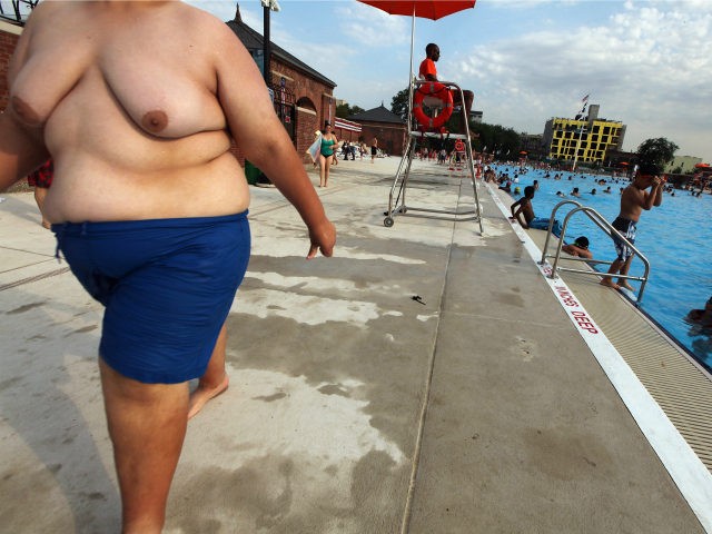 People walk and bathe on opening day of the newly renovated McCarren Park Pool on June 28, 2012 in the Brooklyn borough of New York City. The historic 37,000 square-foot pool had been closed since 1983 but has been rejuvenated by a $50 million restoration. New York City public swimming …