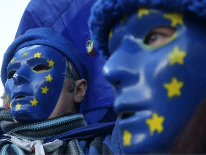 Pro-European Union, (EU), anti-Brexit demonstrators wear masks featuring the EU flag outside the Houses of Parliament in central London on December 18, 2017. / AFP PHOTO / Daniel LEAL-OLIVAS (Photo credit should read DANIEL LEAL-OLIVAS/AFP/Getty Images)