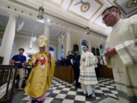 This photograph taken on February 14, 2017 shows Archbishop William Goh Seng Chye (L) walking to the altar during a mass at the Roman Catholic Cathedral of the Good Shepherd 120th anniversary in Singapore. Singapore's oldest Roman Catholic church was built by Father Jean-Marie Beurel in 1847 and underwent extensive …