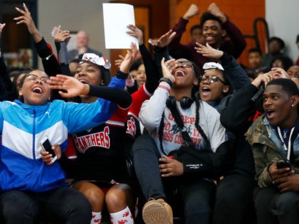 In this Feb. 16, 2018, photo, University Prep Academy High School students react in Detroit to an announcement that all 600 students will see the film "Black Panther." As the film debuts in theaters across the U.S., educators, philanthropist, celebrities, and business owners are pulling together their resources to bring …