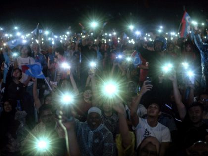 teens holding up their smartphone flashlights