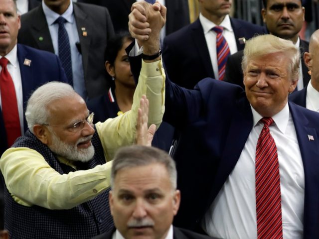 President Donald Trump and Indian Prime Minister Narendra Modi walk around NRG Stadium wav