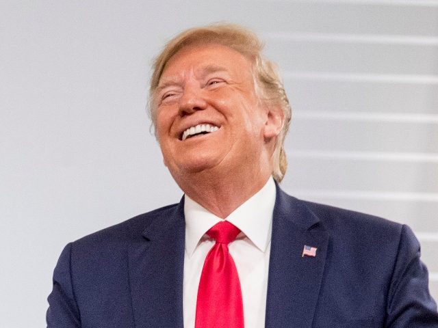 U.S. President Donald Trump and German Chancellor Angela Merkel laugh during a bilateral meeting at the G-7 summit in Biarritz, France, Monday, Aug. 26, 2019. (AP Photo/Andrew Harnik)