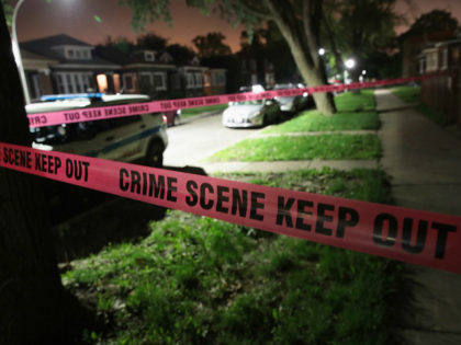 CHICAGO, IL - MAY 27: Crime scene tape is stretched around the front of a home where a man