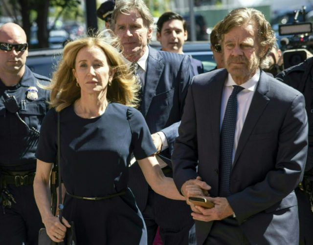 Actress Felicity Huffman, shown arriving at Boston's federal courthouse on September 13, 2019 escorted by her husband William H. Macy, had pleaded guilty to paying $15,000 to boost her daughter's SAT college entrance exam score Actress Huffman gets 14 days jail in US college admissions scandal
