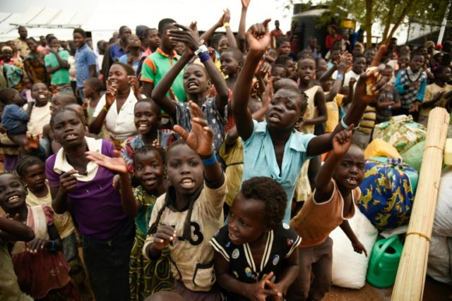 Young refugees from the Democratic Republic of Congo wait to be registered at the Kyangwali Refugee Settlement in western Uganda, on December 10, 2018