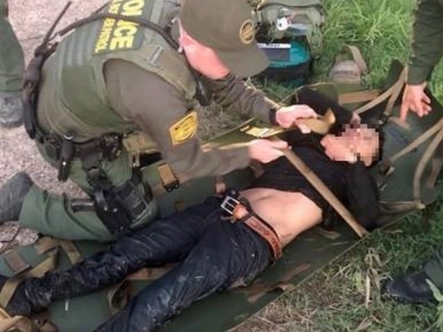 Rio Grande Valley Sector Border Patrol agents evaluate a migrant who nearly drowned while