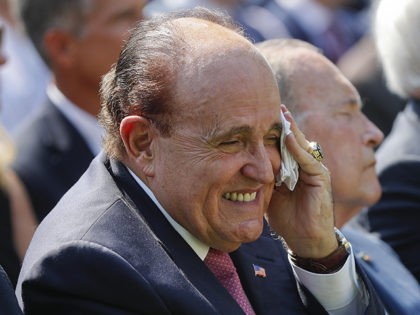 Rudy Giuliani, an attorney for President Donald Trump, center, wipes his forehead as he li