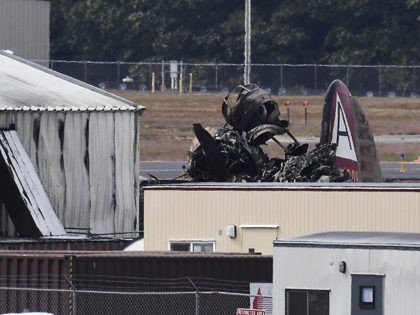 Wreckage is seen where World War II-era bomber plane crashed at Bradley International Airport in Windsor Locks, Conn., Wednesday, Oct. 2, 2019. A fire with black smoke rose from near the airport as emergency crews responded. The airport said in a message on Twitter that it has closed. (AP Photo/Jessica …