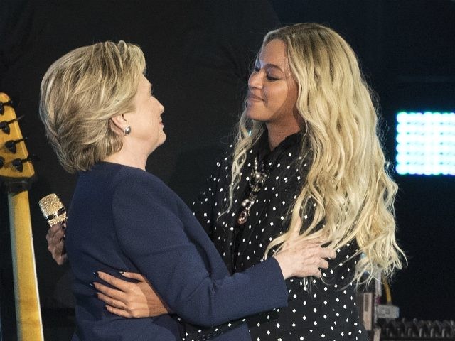 Beyonce, right, and Democratic presidential candidate Hillary Clinton embrace during a campaign rally in Cleveland, Friday, Nov. 4, 2016. (AP Photo/Matt Rourke)