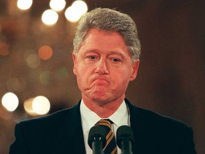 WASHINGTON, : US President Bill Clinton listens to a reporter's question 11 January during