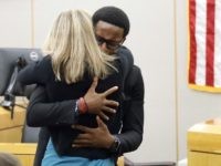 Brandt Jean and Amber Guyger (Tom Fox / Dallas Morning News via Associated Press)