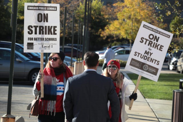 CHICAGO, ILLINOIS - OCTOBER 17: Striking teachers are asked to leave as they picket outside the McCormick YMCA as Chicago Mayor Lori Lightfoot visits with children at the facility who were affected by the teachers' strike on October 17, 2019 in Chicago, Illinois. About 25,000 Chicago school teachers went on …