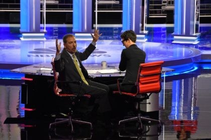 Moderators Chuck Todd (L) speaks to audience during a technical problem alongside Rachel M