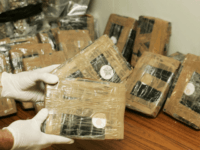 BRUSSELS, BELGIUM - APRIL 24: Confiscated bags containing cocaine are displayed at the Brussels Federal Police station on April 24, 2007 in the Belgian capital Brussels. 350 kg of marijuana and 15 kg of cocaine were seized in downtown Brussels. The marijuana was ready to be transported to the UK …