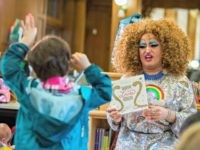 In this Saturday, May 13, 2017 photo, Lil Miss Hot Mess reads to children during the Feminist Press' presentation of Drag Queen Story Hour! at the Park Slope Branch of the Brooklyn Public Library, in New York. (AP Photo/Mary Altaffer)