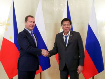 Russian Prime Minister Dmitry Medvedev (L) shakes hands with Philippine President Rodrigo