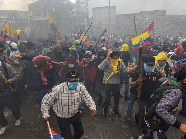 Demonstrators clash with riot police near the national assembly in Quito on October 8, 2019 following days of protests against the sharp rise in fuel prices sparked by authorities' decision to scrap subsidies. - Thousands of demonstrators converged on the Ecuadoran capital Quito on Tuesday as intensifying protests against soaring …