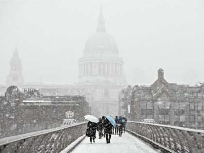 LONDON, UNITED KINGDOM - MARCH 02: Saint Paul's Cathedral is just visible through a blizzard as people cross the River Thames on March 2, 2018 in London, United Kingdom. Weather fronts dubbed Storm Emma and The Beast From The East have combined to create freezing conditions that have bought much …