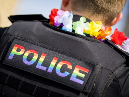 BRIGHTON, ENGLAND - AUGUST 04: A police officer joins the parade during Brighton Pride 20