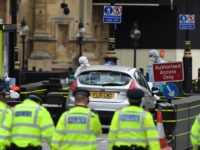 LONDON, ENGLAND - AUGUST 14: A general view of Police officers searching the scene as forensic officers work on the vehicle that crashed into security barriers, injuring a number of pedestrians early this morning, outside the Houses of Parliament on August 14, 2018 in London, England. A man has been …