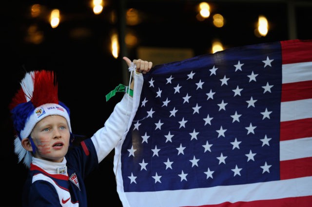 PRETORIA, SOUTH AFRICA - JUNE 23: A young USA fan with his national flag as he enjoys the