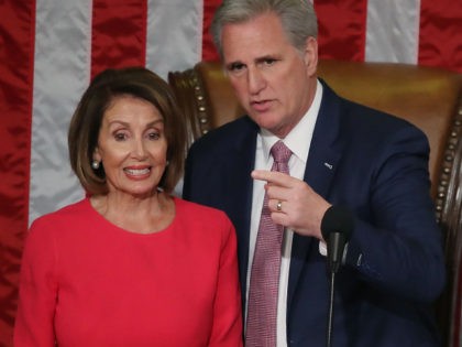 WASHINGTON, DC - JANUARY 03: Outgoing House Majority Leader Kevin McCarthy (R-CA) stands with Speaker of the House designate Nancy Pelosi (D-CA) before she is sworn in sworn in during the first session of the 116th Congress at the U.S. Capitol January 3, 2019 in Washington, DC. Under the cloud …