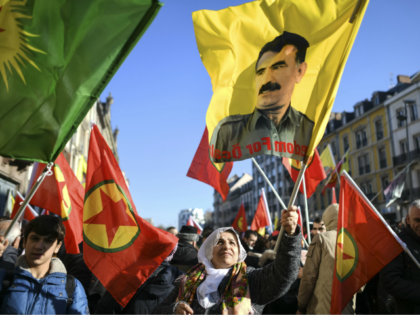 A woman holds a flag with the portrait of Kurdish leader Abdullah Ocalan during a demonstration in Strasbourg, eastern France, on February 16, 2019, to mark 20 years since the arrest of Ocalan, who is jailed in Turkey. - Labelled the "nemesis" of the Turkish state, Ocalan remains a revered …