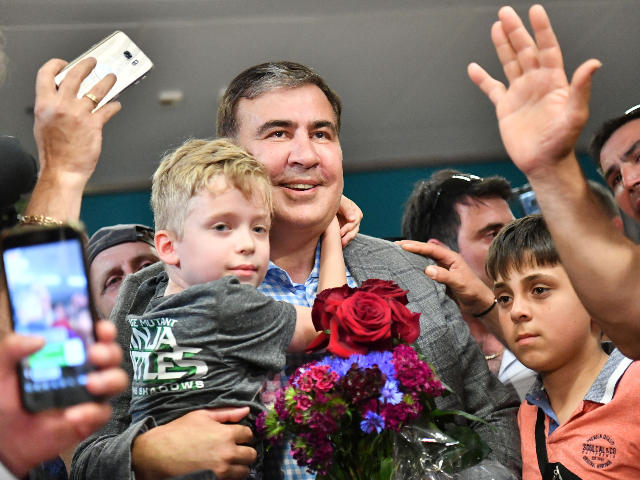 Former Georgian leader Mikheil Saakashvili (C) is greeted by his supporters after his arri
