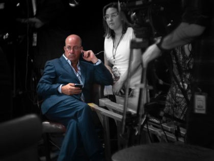 Jeff Zucker, President of CNN, watches productions in the spin room after the second debat