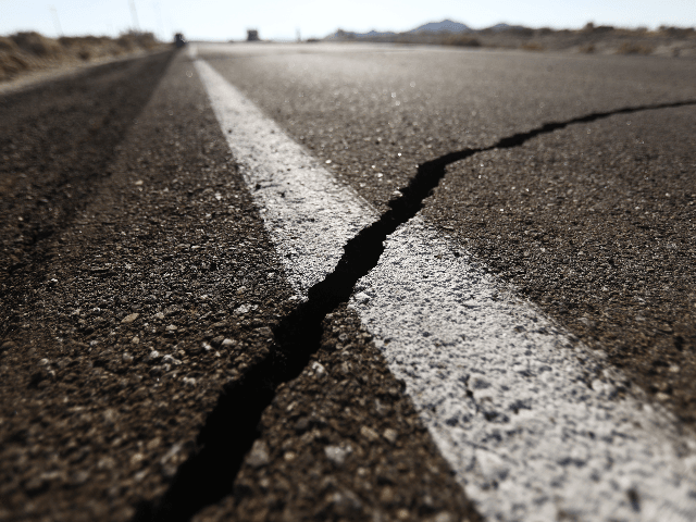 A crack stretches across the road after a 6.4 magnitude earthquake struck the area on July