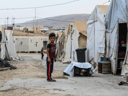 A boy stands in an alley between tents at a camp for internally displaced persons (IDP) of Iraq's Yazidi minority in the Sharya area, some 15 kilometres from the northern city of Dohuk in the autonomous Iraqi Kurdistan region on August 30, 2019. (Photo by Zaid AL-OBEIDI / AFP) (Photo …
