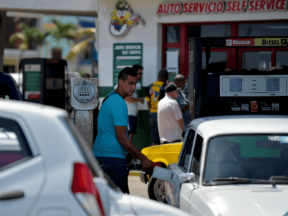A man fills his car with fuel at a gas station in Havana, on September 19, 2019. - Cuban P