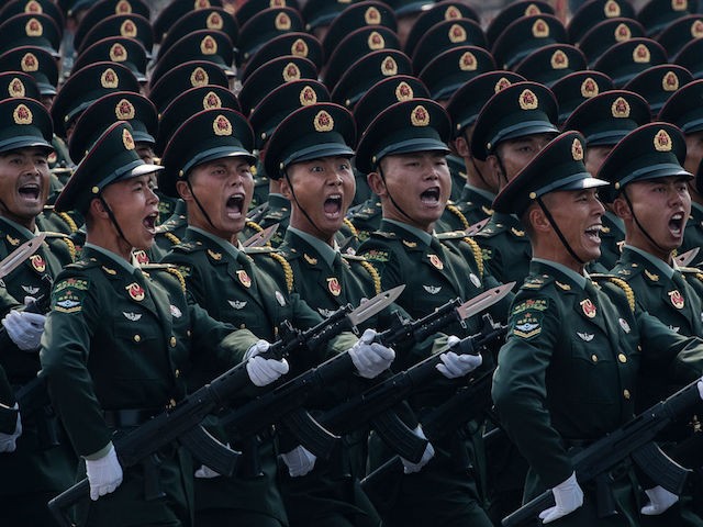 BEIJING, CHINA - OCTOBER 01: Chinese soldiers shout as they march in formation during a parade to celebrate the 70th Anniversary of the founding of the People's Republic of China at Tiananmen Square in 1949, on October 1, 2019 in Beijing, China. (Photo by Kevin Frayer/Getty Images)