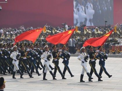 Chinese soldiers march with the national flag (C), flanked by the flags of the Communist Party of China (R) and the People's Liberation Army (L) during a military parade at Tiananmen Square in Beijing on October 1, 2019, to mark the 70th anniversary of the founding of the People's Republic …