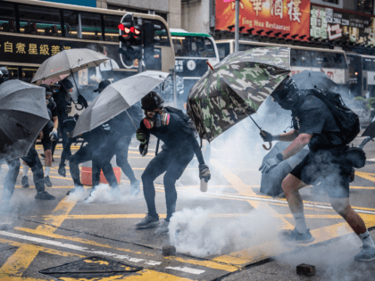 Protesters clash with police during a protest in Kowloon on October 6, 2019 in Hong Kong, China. Hong Kong's government invoked emergency powers on Friday to introduce an anti-mask law which bans people from wearing masks at public assemblies as the city remains on edge with the anti-government movement entering …