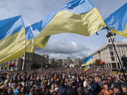 Demonstrators wave Ukraine national flags as they gather in central Kiev on October 6, 2019 to protest broader autonomy for separatist territories, part of a plan to end a war with Russian-backed fighters. - Protesters chanted "No to surrender!", with some holding placards critical of President Volodymyr Zelensky in the …