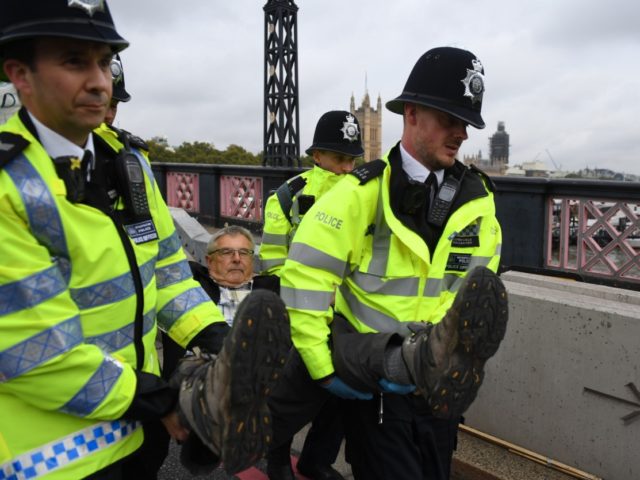 LONDON, ENGLAND - OCTOBER 07: Police remove a protester from Lambeth Bridge on October 7,