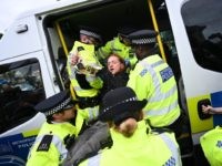 A climate change activist from the Extinction Rebellion group is arrested by police in Trafalgar Square in central London, on October 7, 2019 during the group's global climate protests. - Extinction Rebellion has scheduled non-violent protests chiefly in Europe, North America and Australia over the next fortnight. (Photo by Ben …