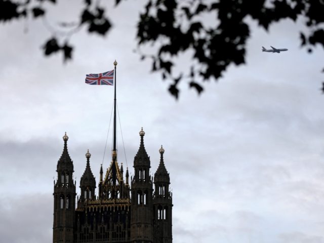 A Union flag flies from a pole atop the Victoria Tower at the Houses of Parliament in Lond