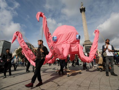TOPSHOT - Activists walk with a giant pink octopus at Trafalgar Square during the fourth d