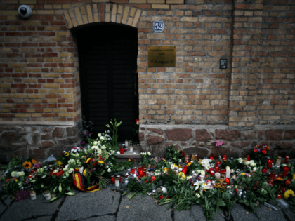 Candles and flowers are seen at a makeshift memorial in front of the synagogue in Halle, eastern Germany, on October 10, 2019, one day after the attack where two people were shot dead. - German leaders visited the scene of the deadly anti-Semitic gun attack carried out on the holy …