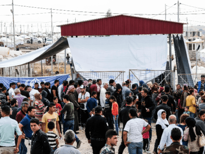 Syrian refugees fleeing the Turkish incursion in Northern Syria wait to receive aid from the UNHCR, local Kurdish non-profit, BCF (Barzani Charity Foundation) and other International NGOs as more than 200 arrive at the facility on October 17, 2019 in Dohuk, Iraq. More than 1000 refugees have arrived in Northern …