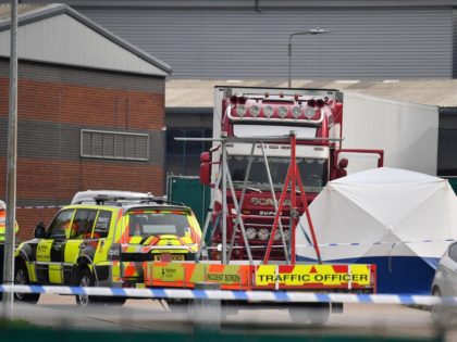 British Police officers stand on duty at a cordon near to where a lorry, believed to have