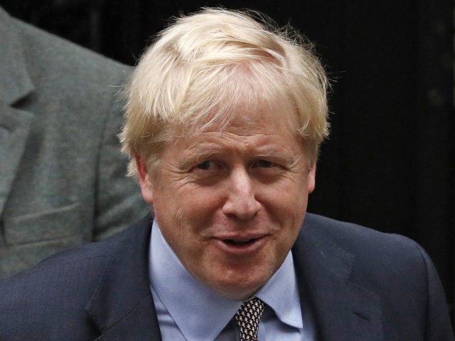 Britain's Prime Minister Boris Johnson gestures as he leaves 10 Downing Street, centr